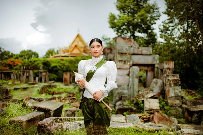 a woman stands in a grassy cemetery