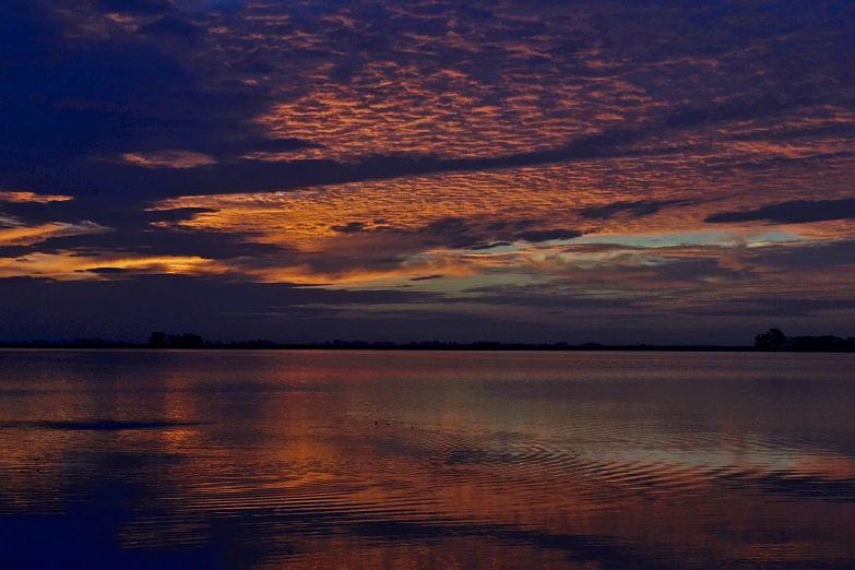 the clouds are reflecting on the still water