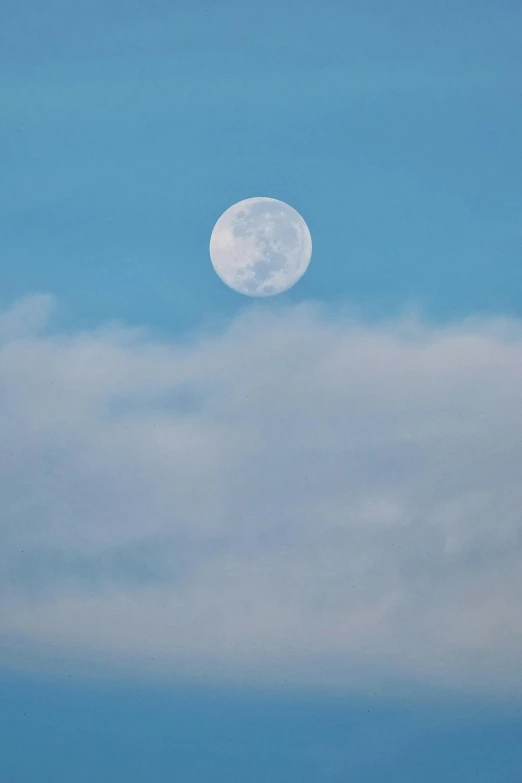 a jet in the sky and a full moon above