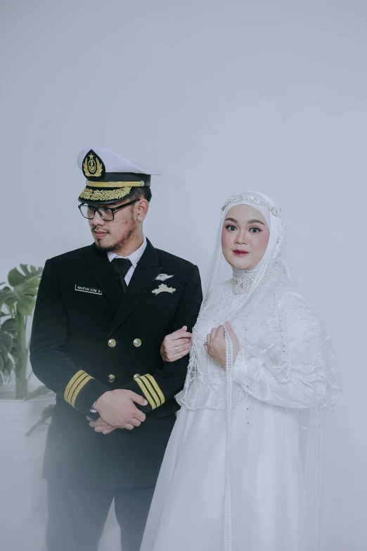a military couple posing for a po in wedding clothes