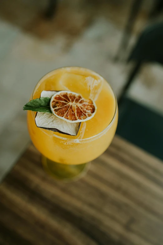 a close up of a glass of an orange cocktail