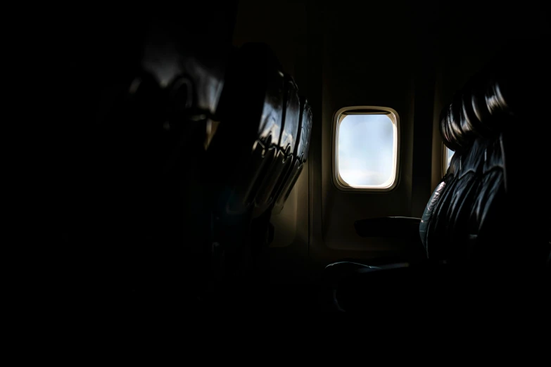 the inside of an airplane cabin looking out into the light