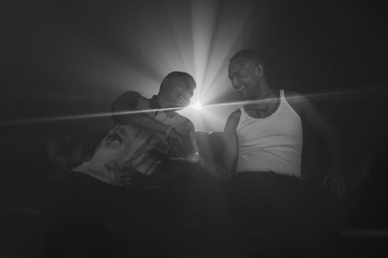 dark po of a light shining on two people