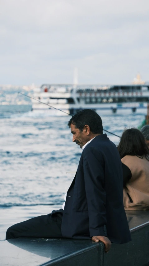 two men and a woman are riding on a boat on the water