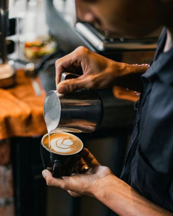 a man holding a coffee cup filled with liquid