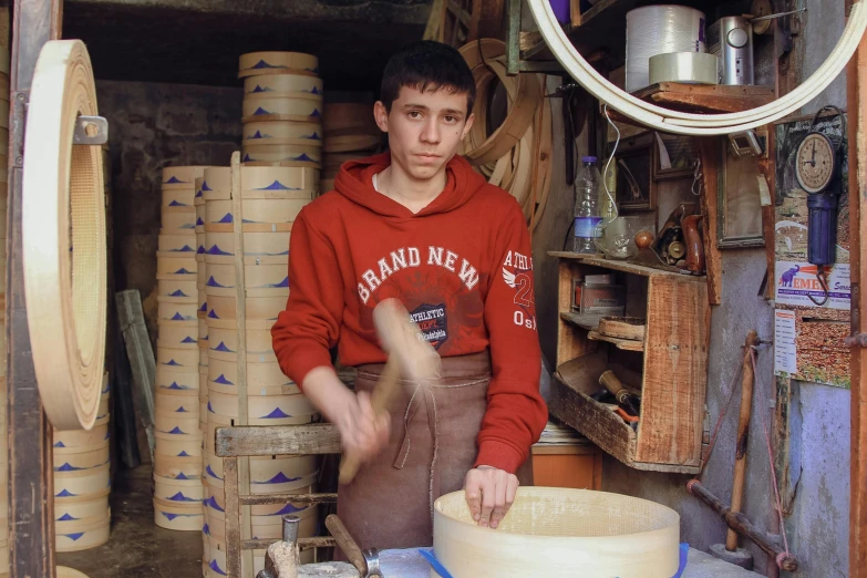 the boy is working on the pottery work