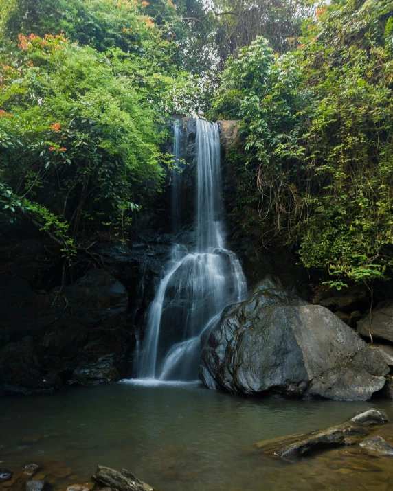 a waterfall cascades into a large body of water