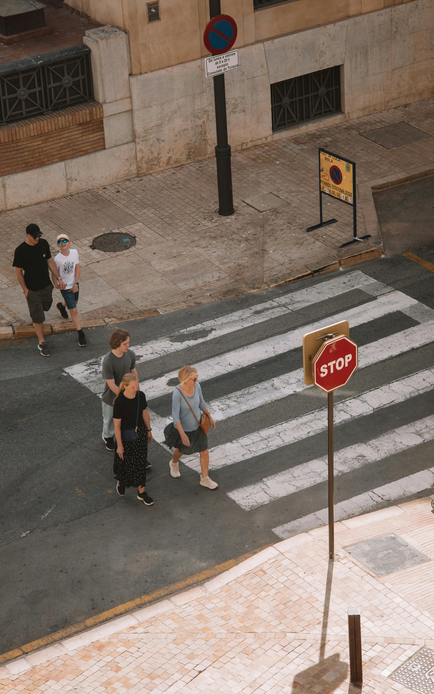 a group of people walking across a street