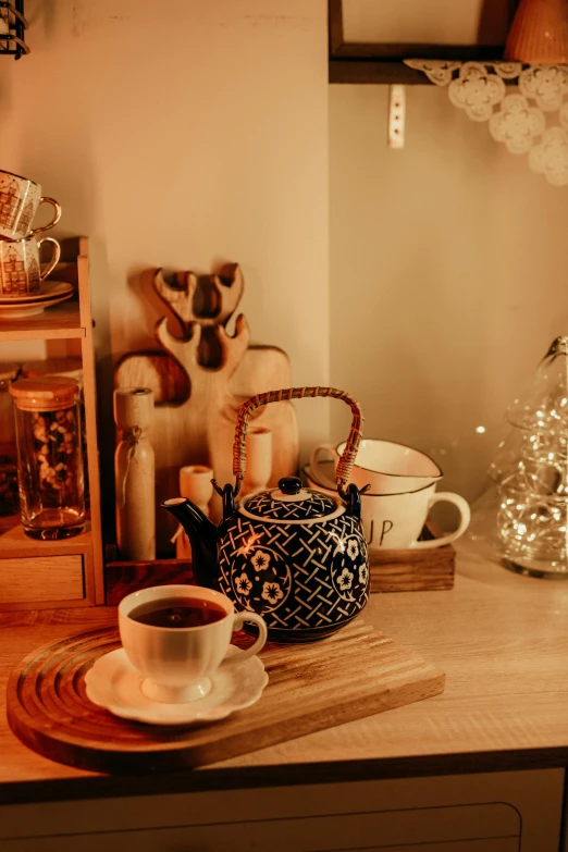 some tea cups that are on a wooden table