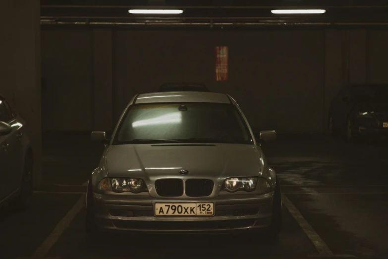 an empty parking space with two bmw cars