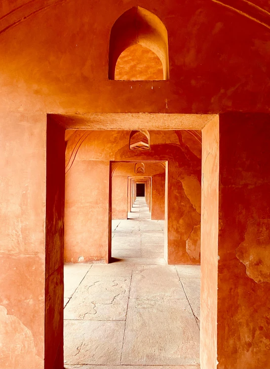 an empty hallway inside a building with arched doorways