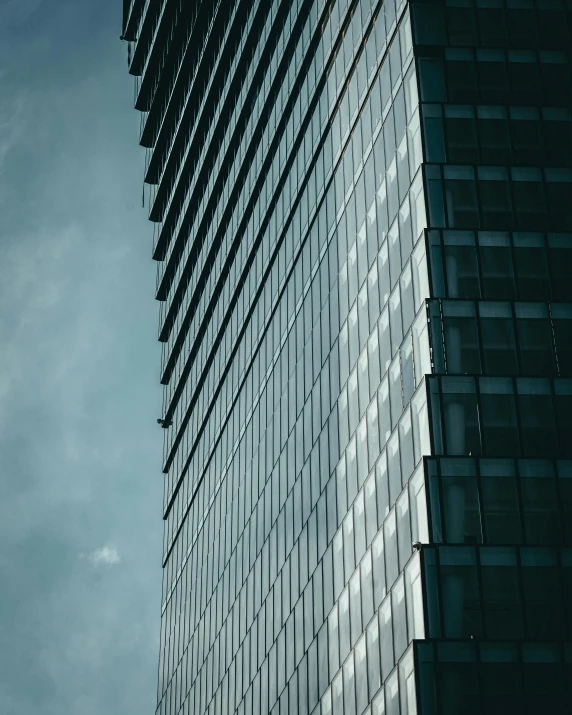 a plane flying past a tall building in the sky