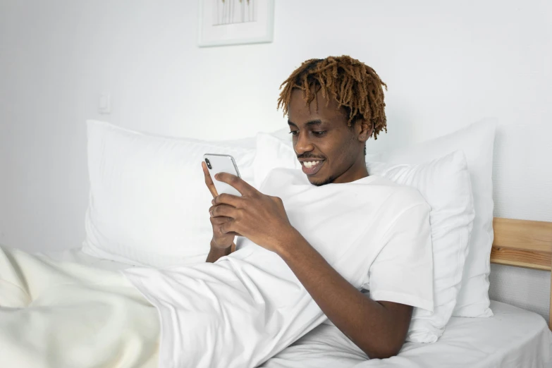 a woman in white is looking at her phone