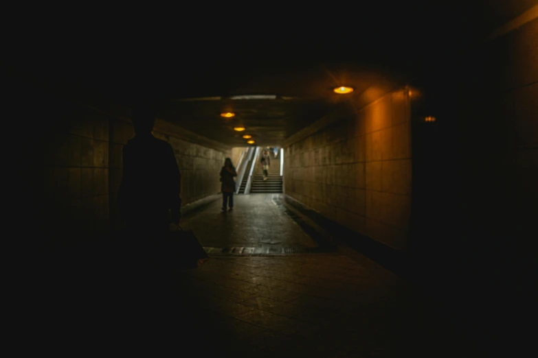 a man in the shadows walking into a dark hallway