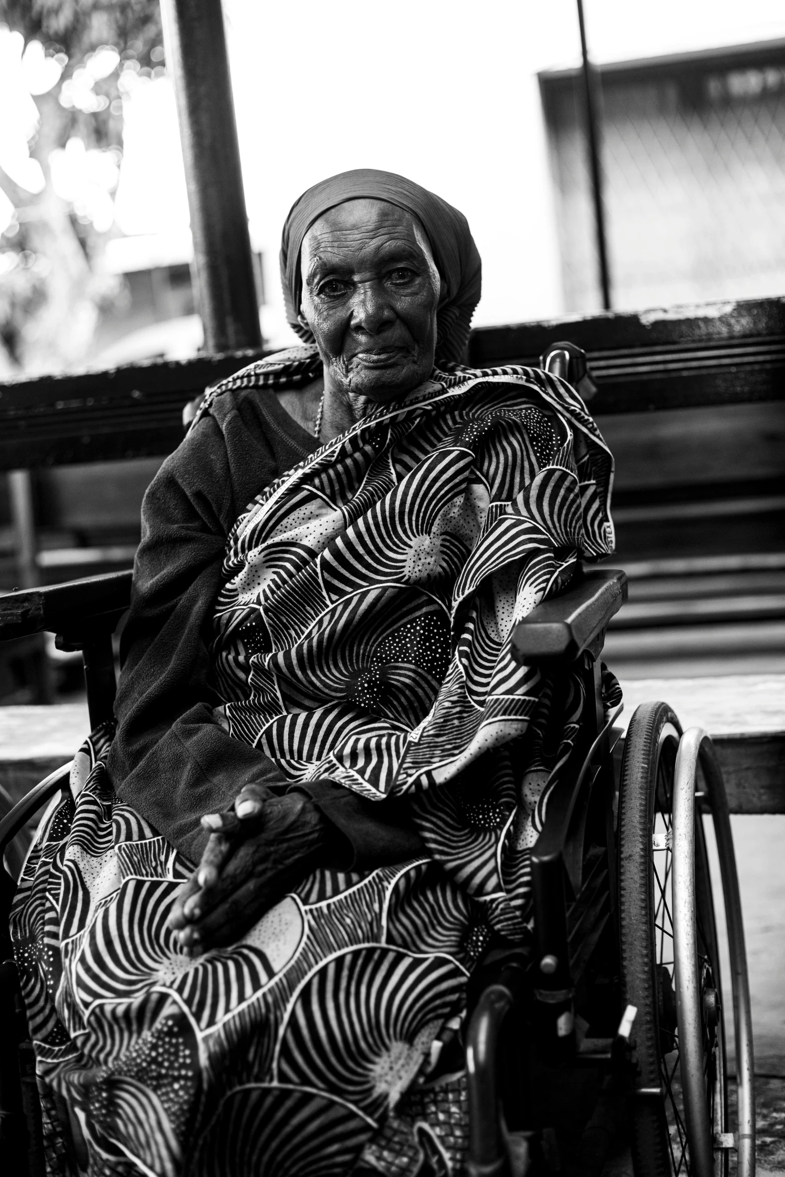 black and white pograph of an old woman in a wheelchair