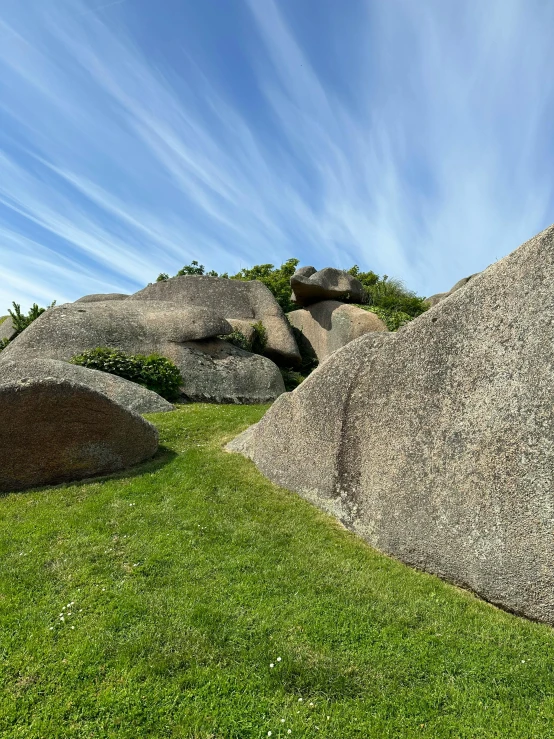 rocks and grass in the foreground under a blue sky