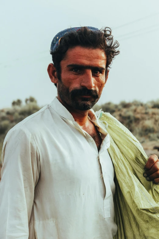 a man with his clothes on is standing in the desert