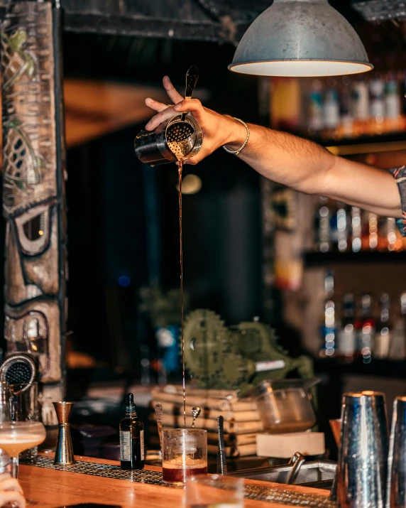 a person pouring a cup of some kind