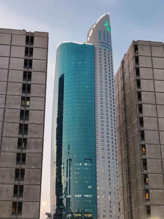 some tall buildings near one another on a busy street