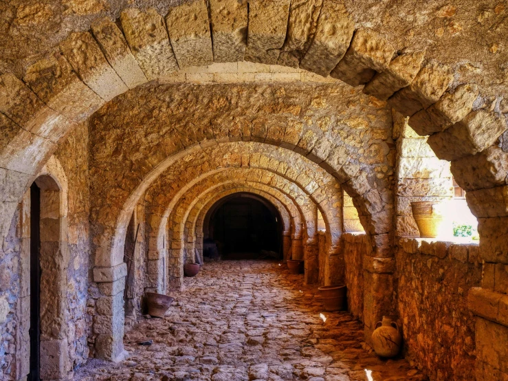 a narrow tunnel of stone is built into an old building