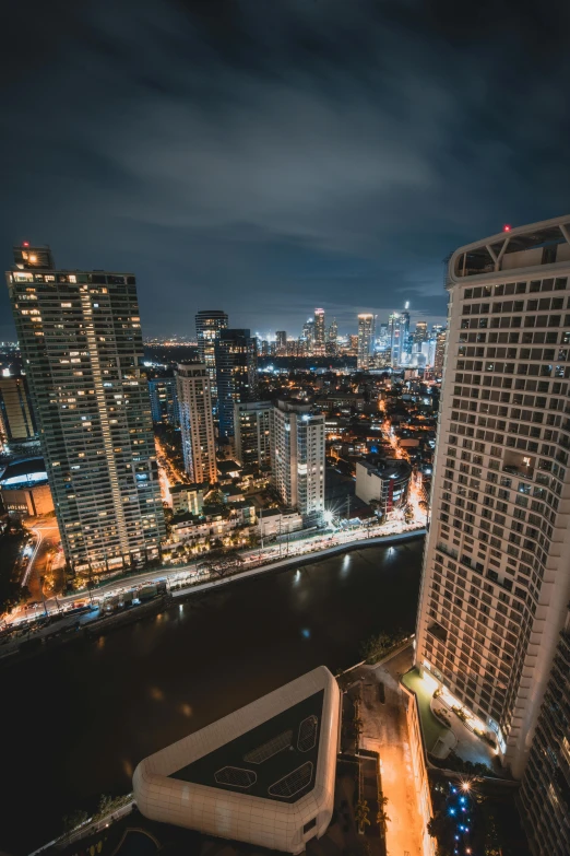 a very tall building sitting next to a body of water