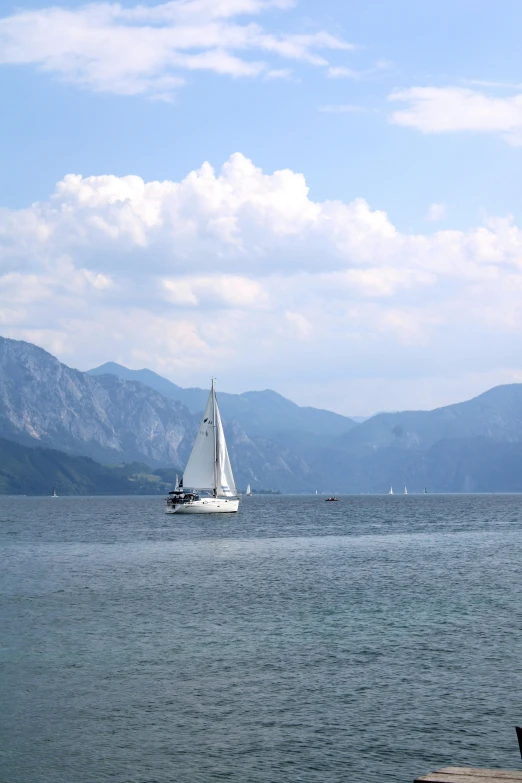 a small sail boat floats on the open water