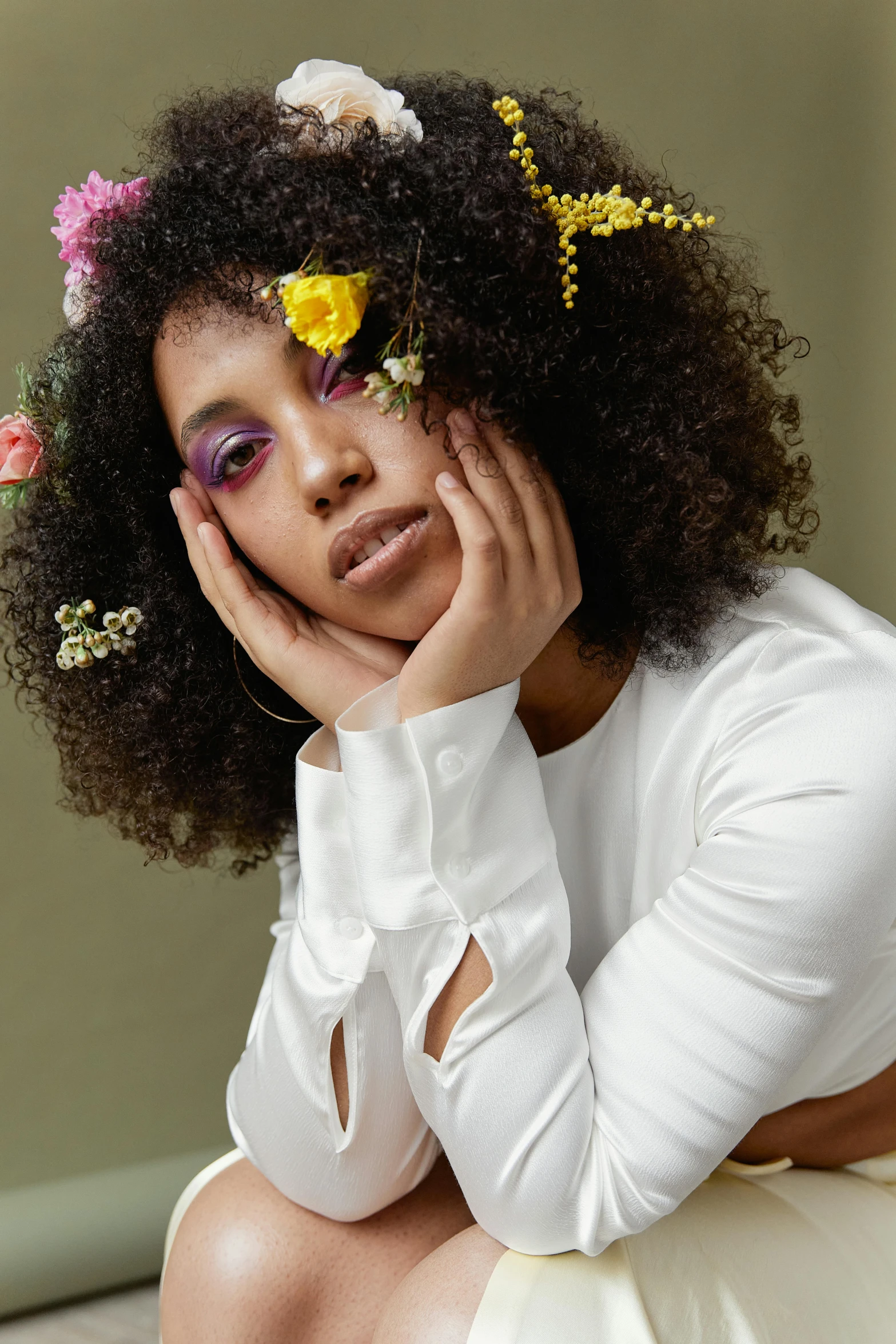 a beautiful young black woman with flowers in her hair