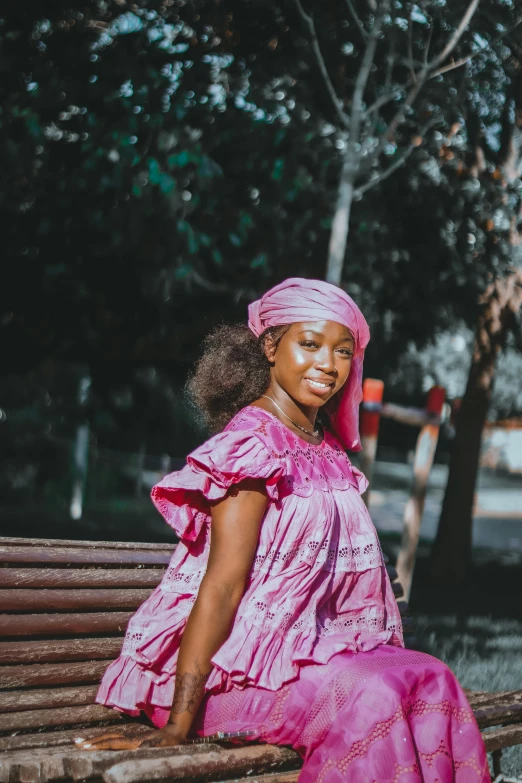 a woman is dressed up and sitting on a bench