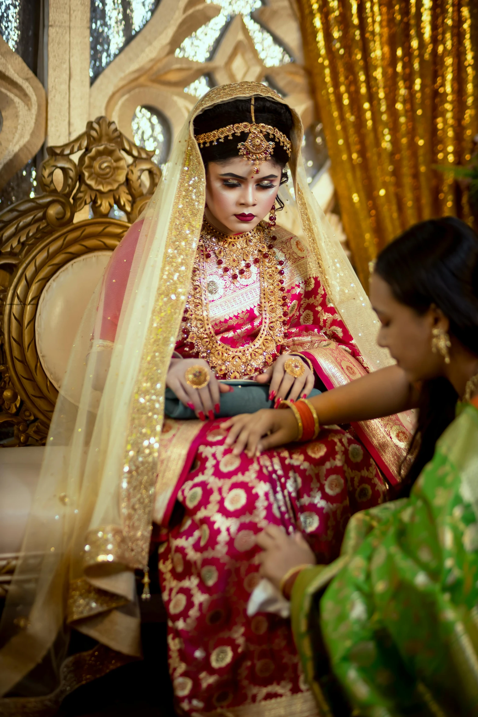 an indian bride and maid prepare to perform hindu ceremony