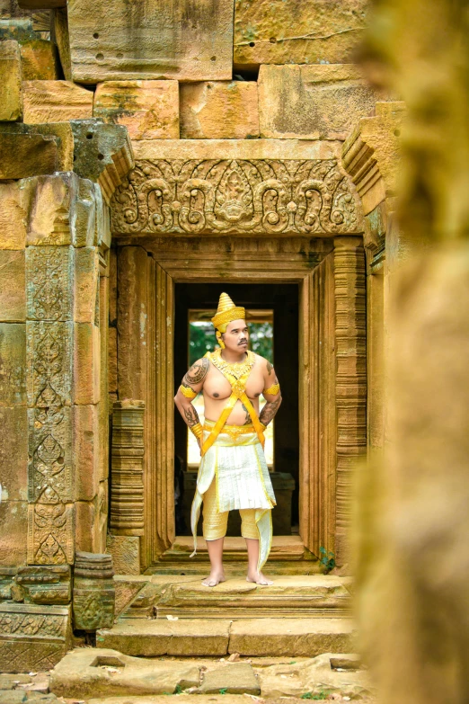 a man in a white and yellow outfit is standing in the doorway