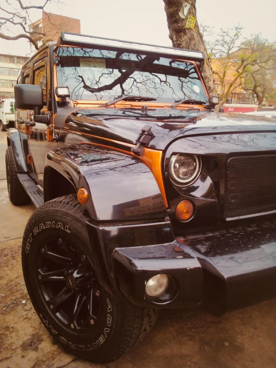 a black vehicle that is parked on a side walk