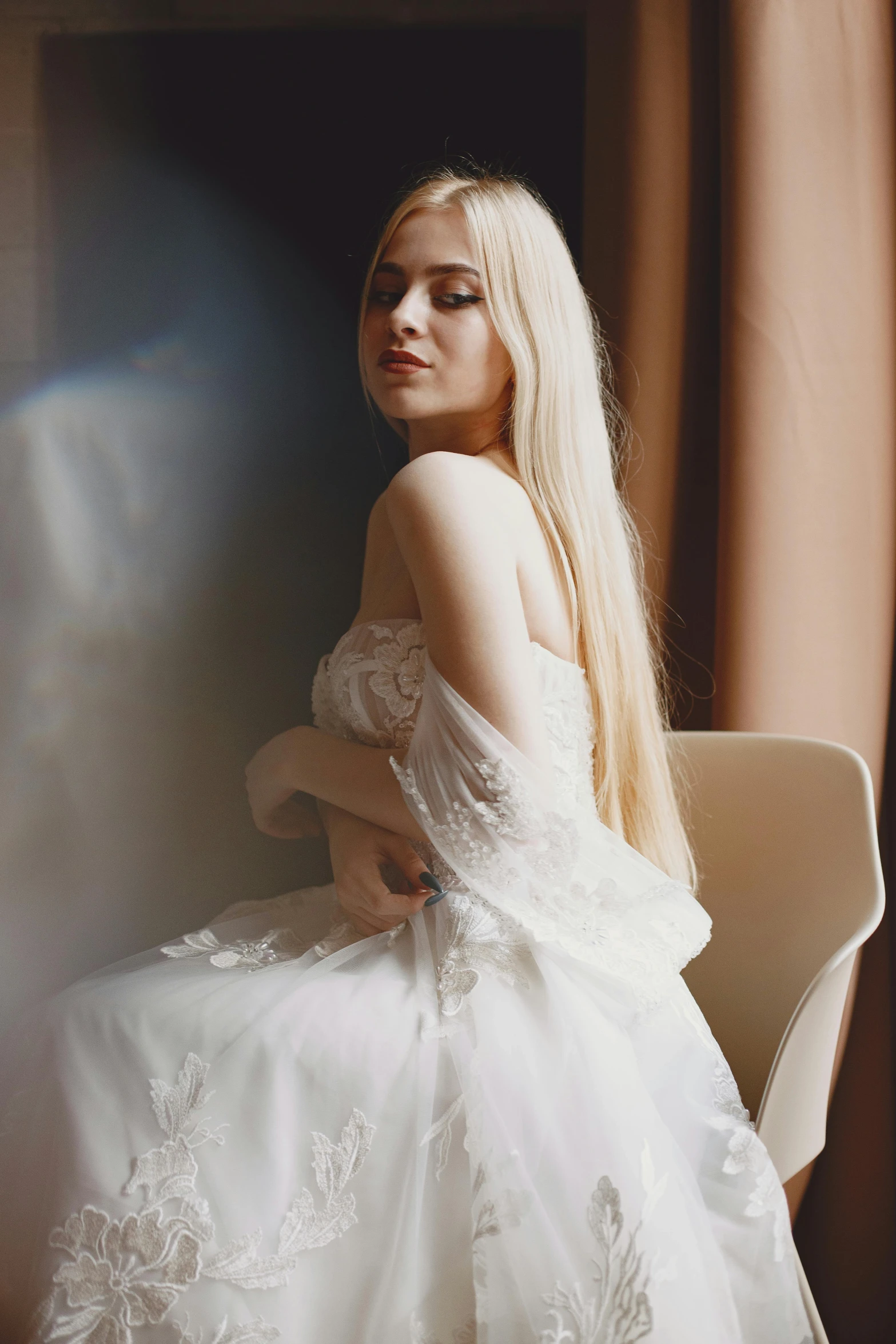 a beautiful woman sitting in a chair posing for a po