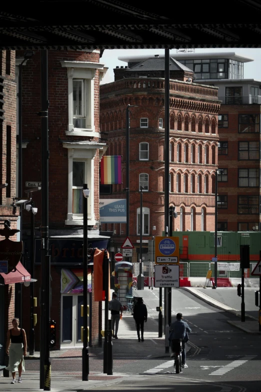 people are crossing the intersection of a city street