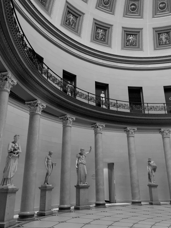 an atrium with large sculptures and a dome