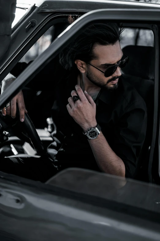 a man with sunglasses and a watch on his wrist