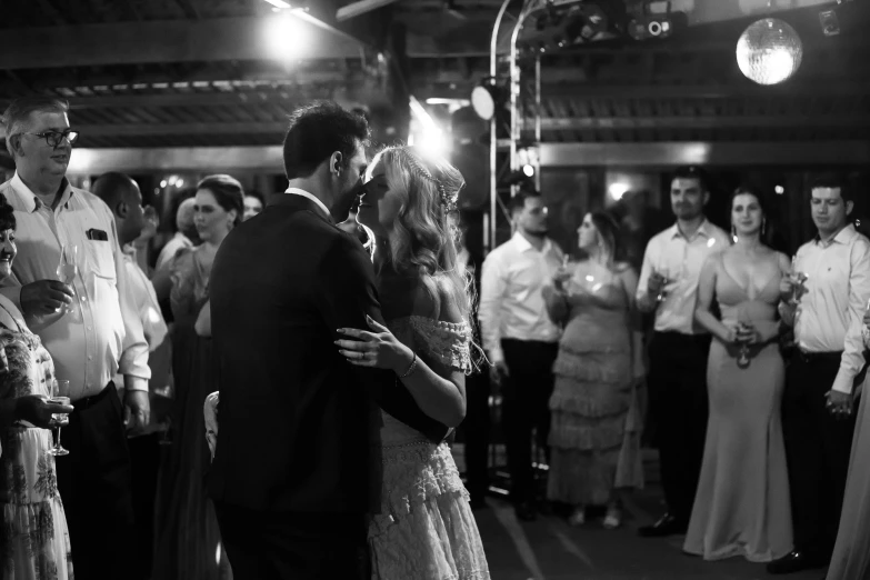 a bride and groom share their first dance at a wedding reception