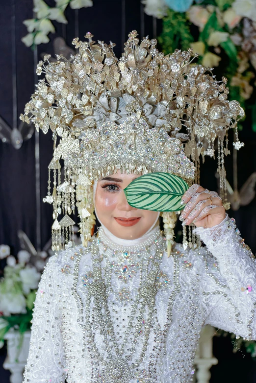 a woman is wearing a decorative head piece