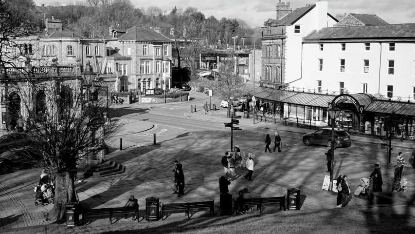 several people are standing in the courtyard of this town