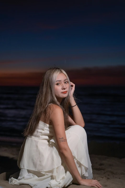 a  sitting on a beach near the ocean