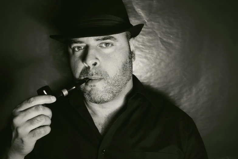 a man wearing a hat smoking a pipe