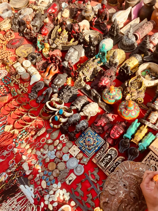 a woman at an outdoor market looking at earrings