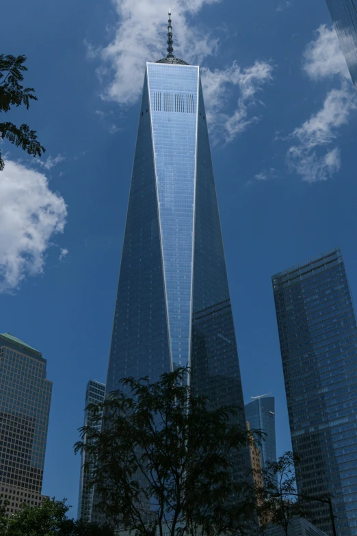 the shard in front of one world trade center on a sunny day