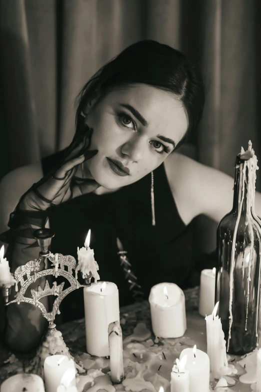 woman in front of a table full of candles