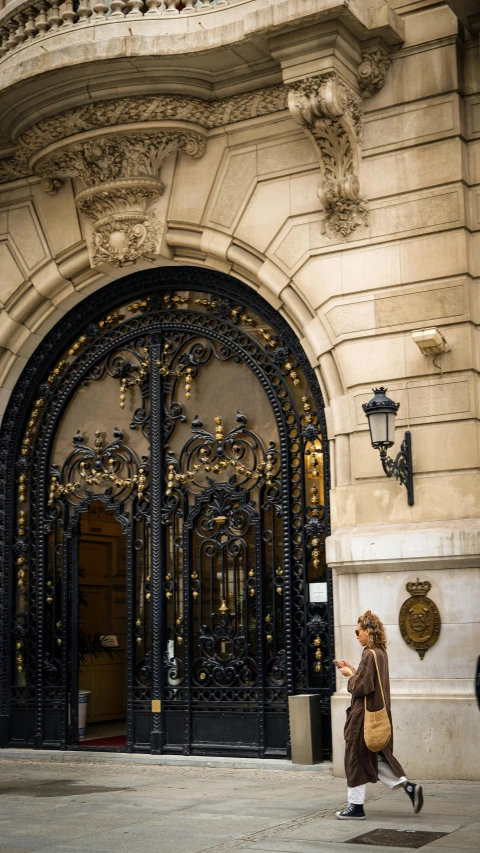 a woman walking past a building doorway