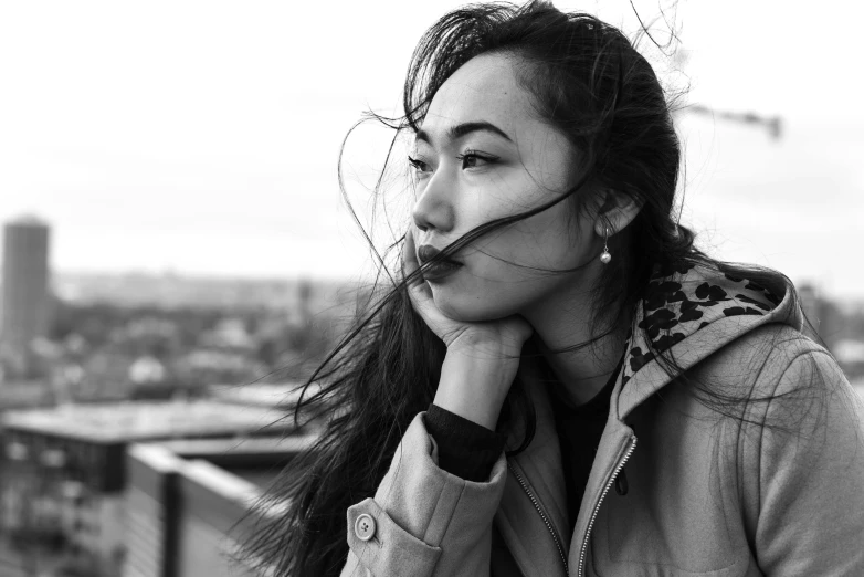 the young woman is posing on top of the building