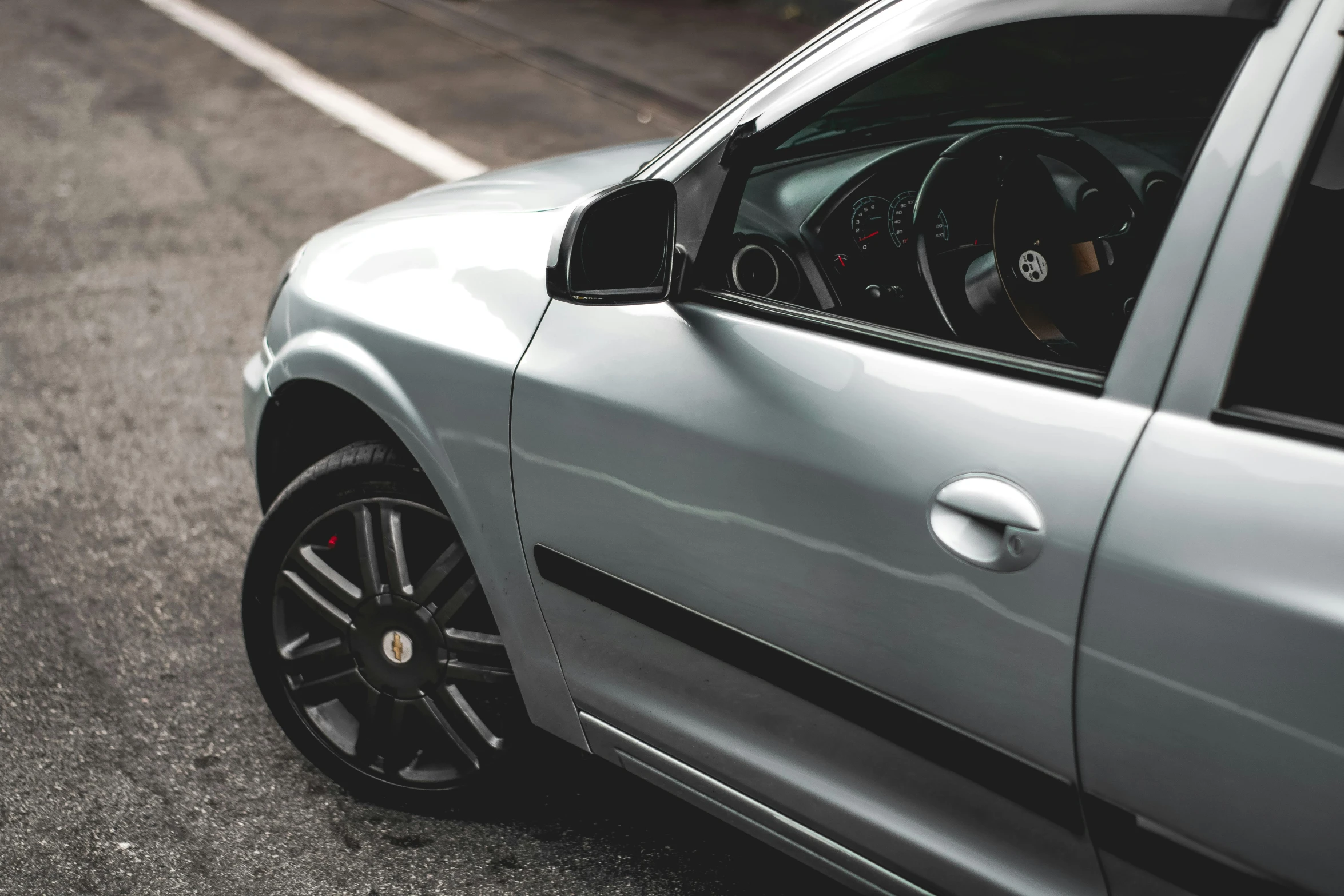 a silver sports car is parked on a street