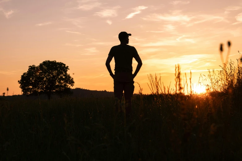 a man standing on top of a lush green field