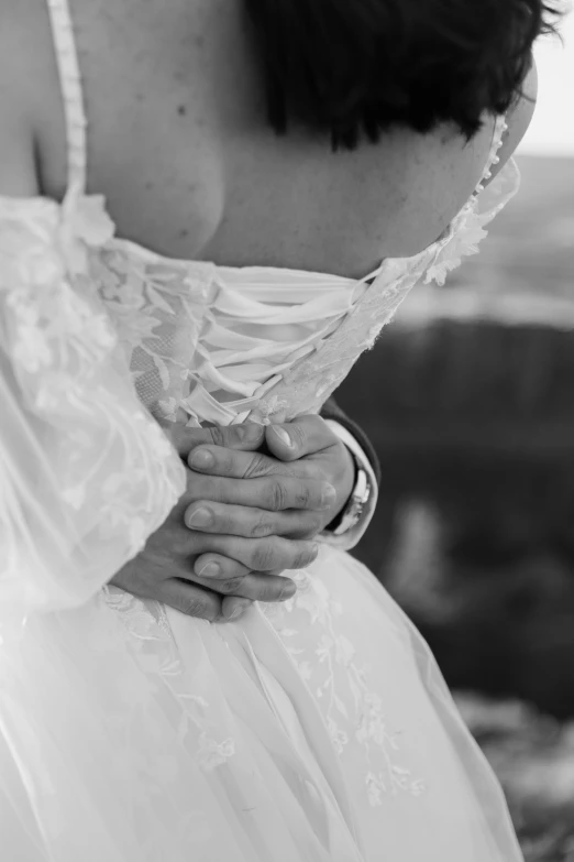 an image of a woman holding her wedding ring