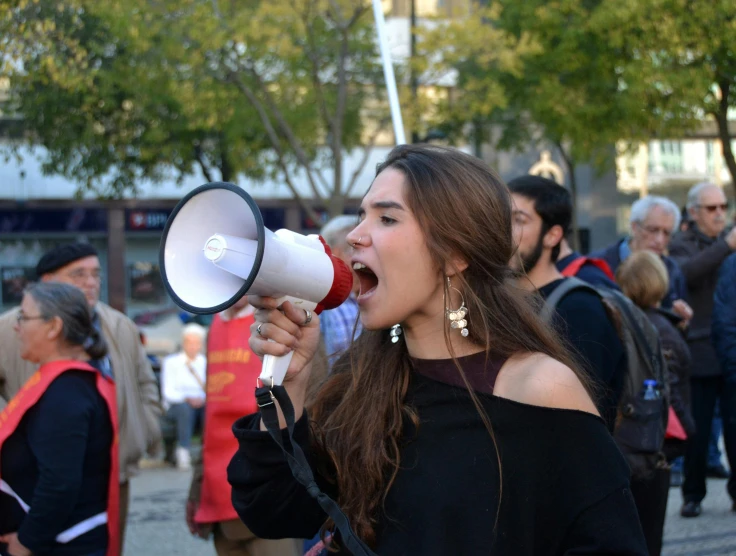 a woman shouting with a megaphone in her hand