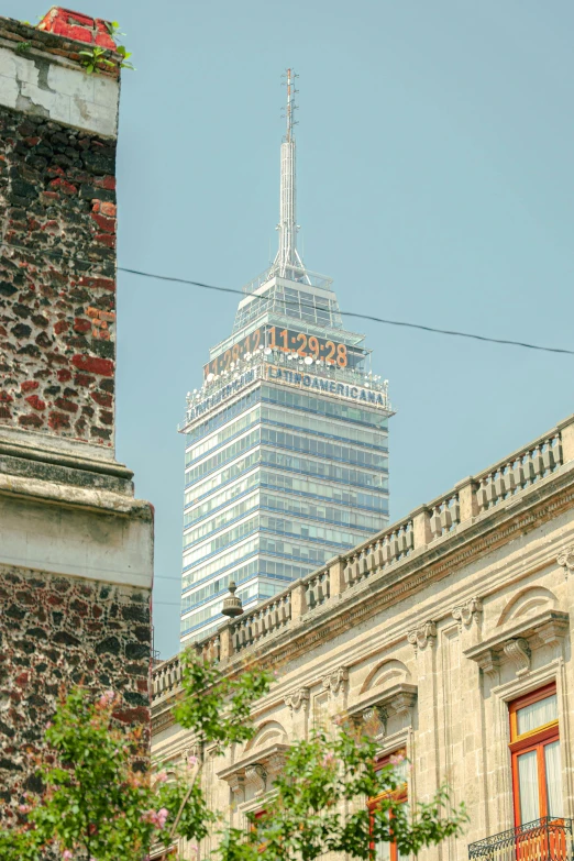 a tall building is seen in the distance behind a city block